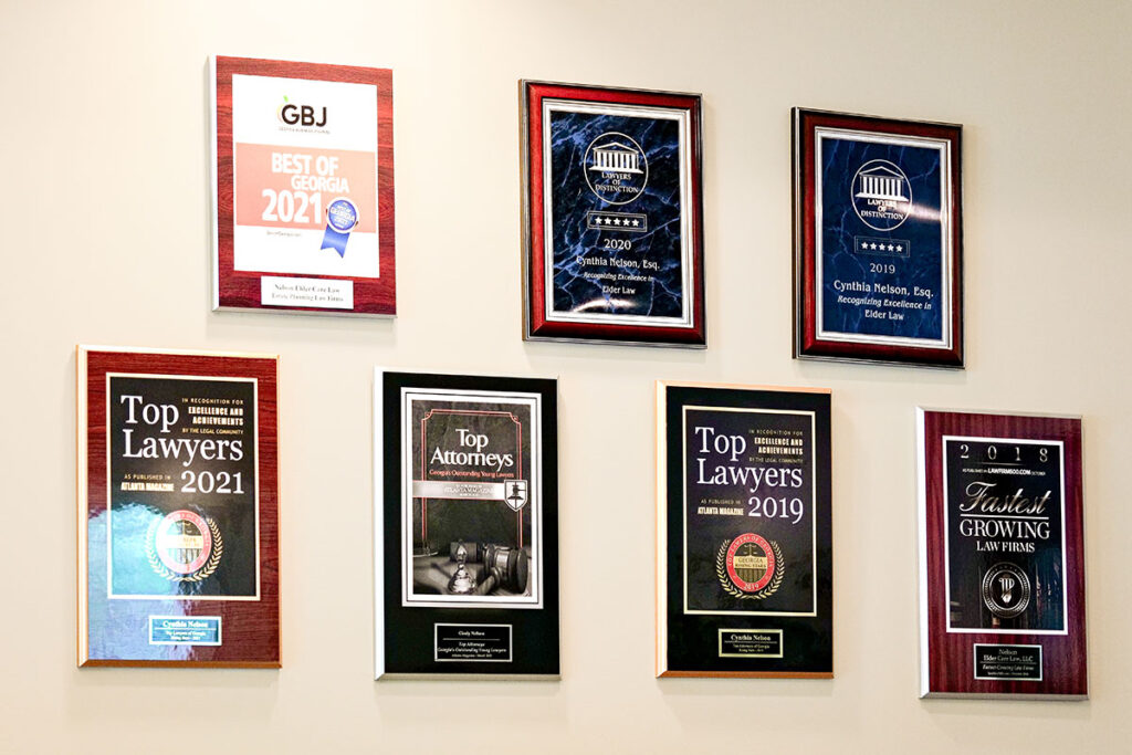 Award plaques on the wall celebrating Nelson Elder Care Law’s achievements over the years.