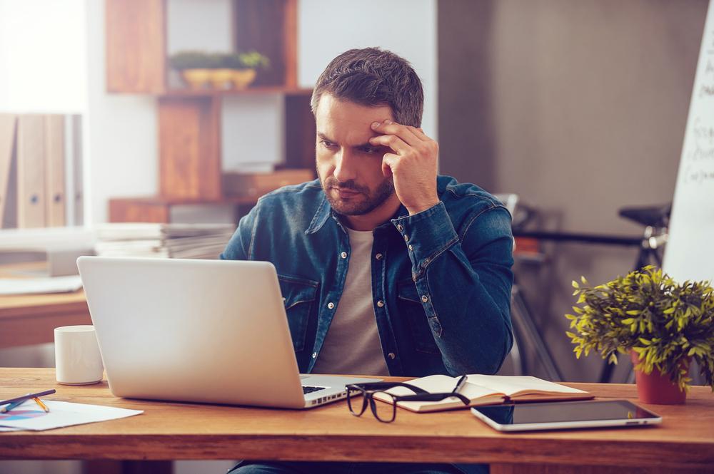 A worried man reviews information on a computer and wonders if a Gainesville elder law attorney can explain estate taxes to him.
