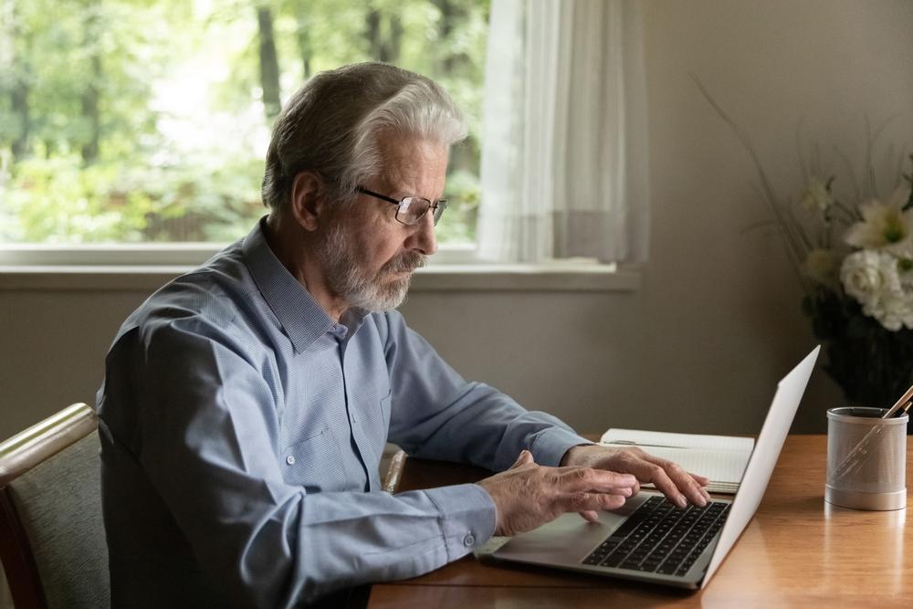 An older man uses a computer to find out if AI can create an estate plan for him.