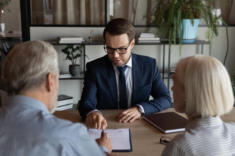 An elder law attorney explains to an older couple what a financial power of attorney is.