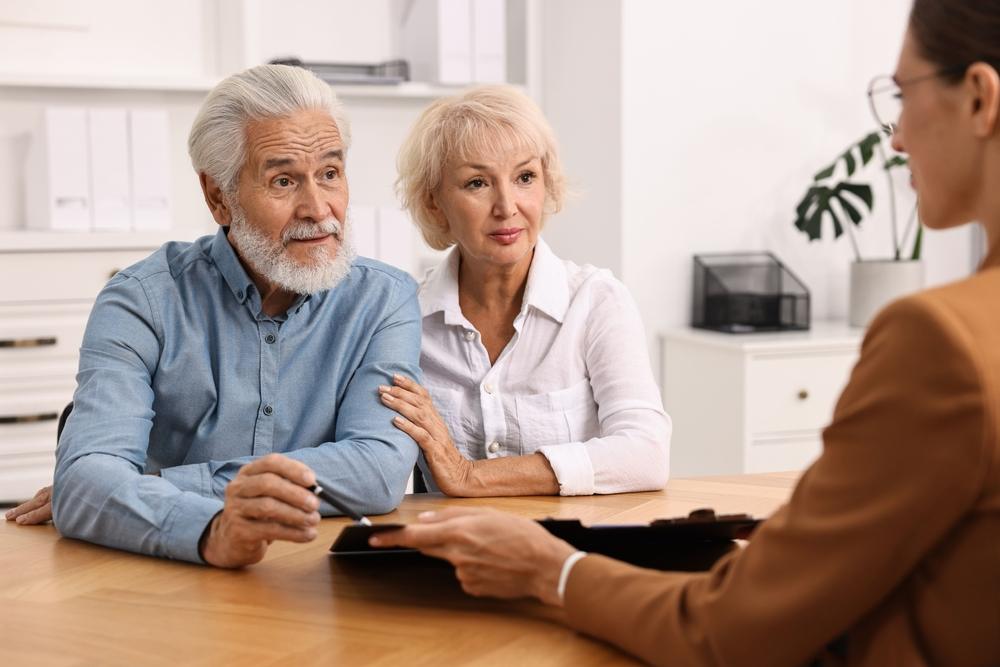 An older couple meets with an attorney to learn what the difference is between a guardian or conservatorship and a power of attorney.