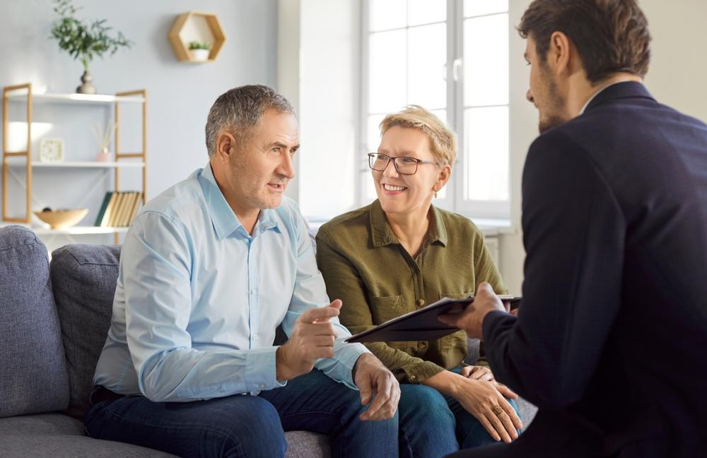 An attorney explains to an older couple what estate planning documents they need.