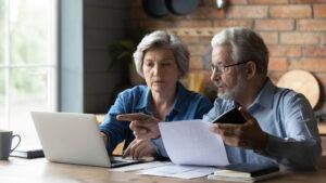 An older couple reviews their finances and wonders how Nelson elder care law works with financial planners. 
