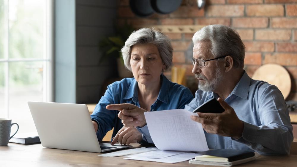 An older couple reviews their finances and wonders how Nelson elder care law works with financial planners. 