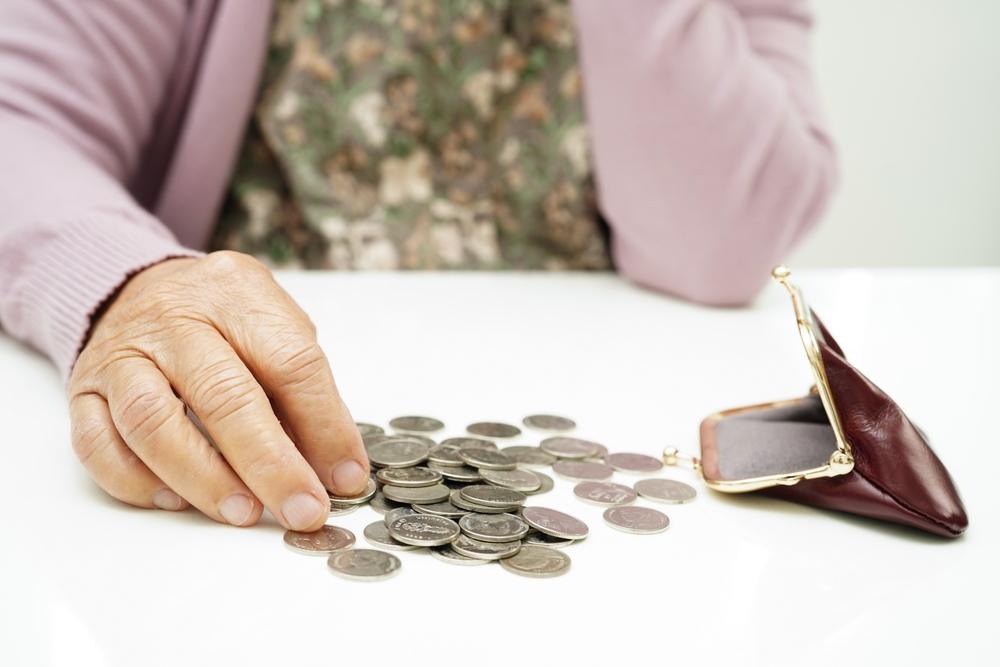 A woman counts coins and wonders if she has to spend all of her money before she can qualify for Medicaid in Georgia.