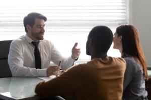 An attorney meets with a couple to discuss what a will caveat is.