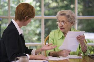 An older woman meets with an elder law attorney to find out what living trusts are.